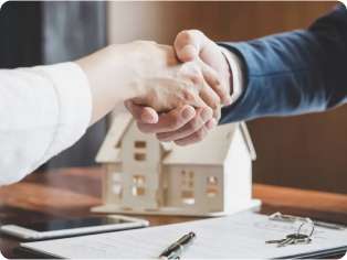 two people shaking hands after closing a real estate deal