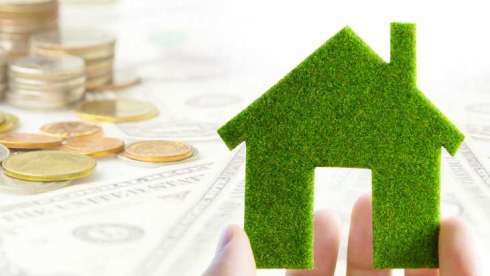 House figure with coins behind representing a property deal.